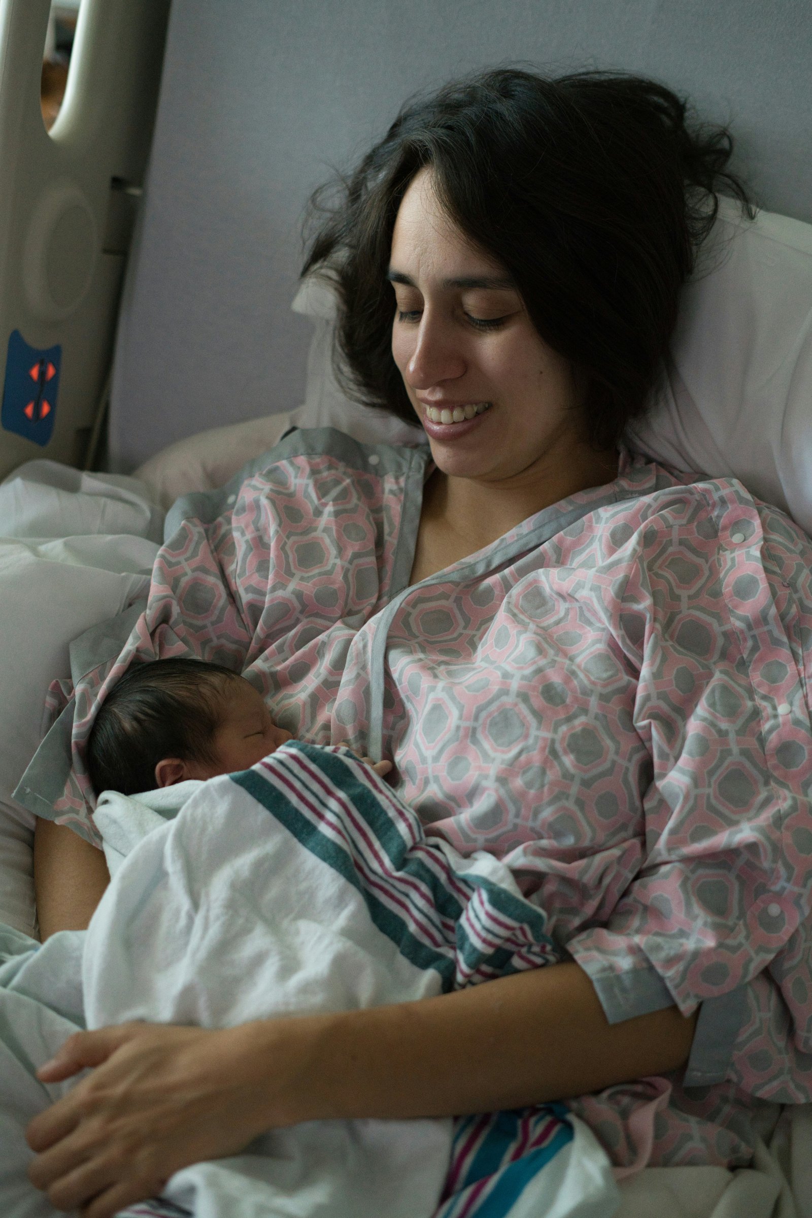 Mother holding newborn in hospital