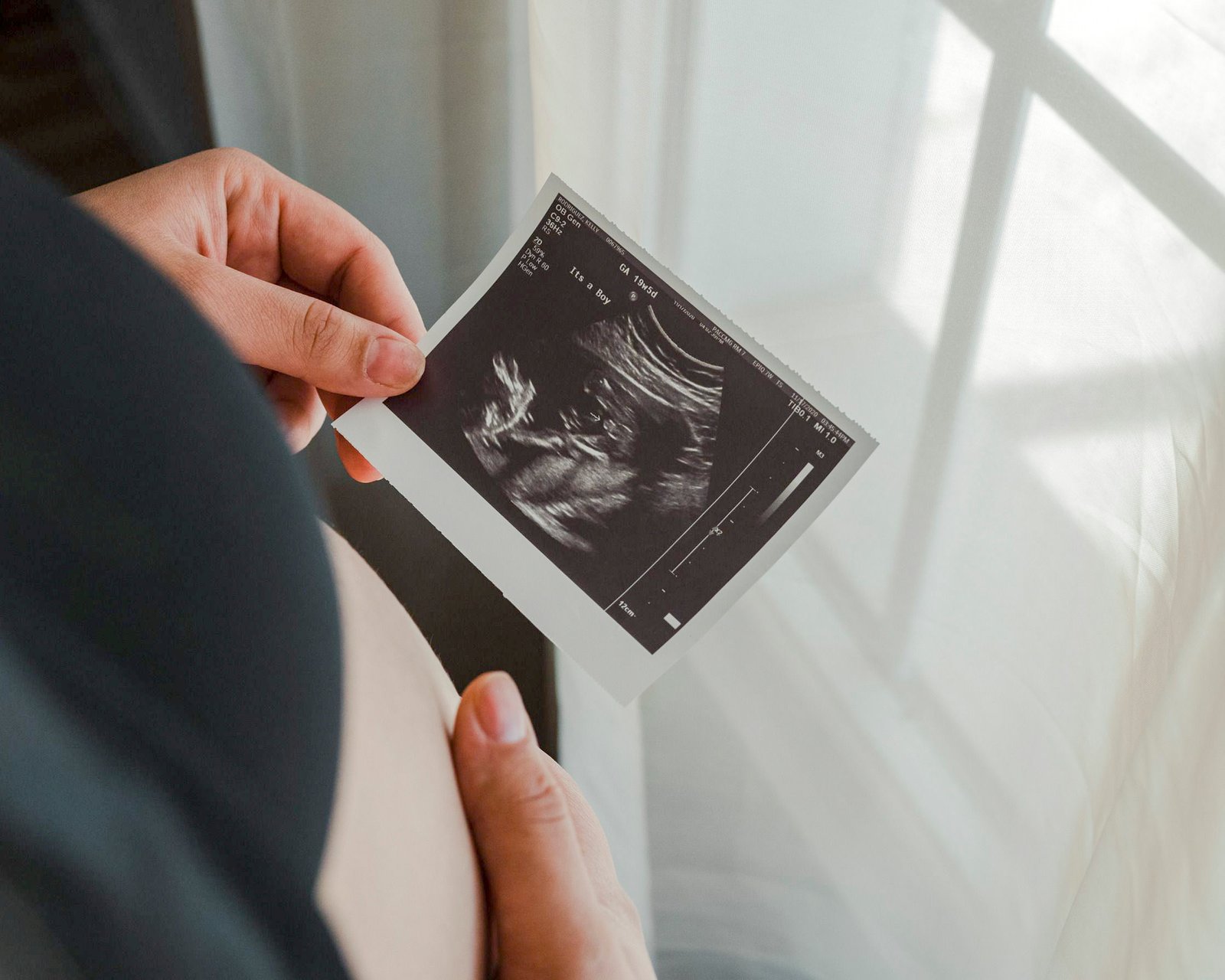 Pregnant woman reviewing ultrasound scan results